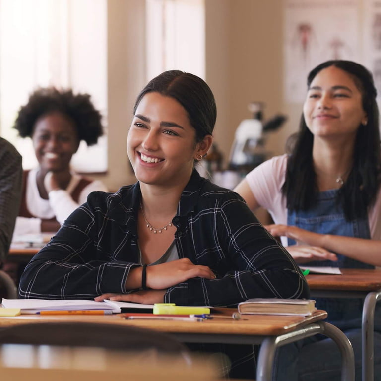 female teenage student smiling in high school classroom